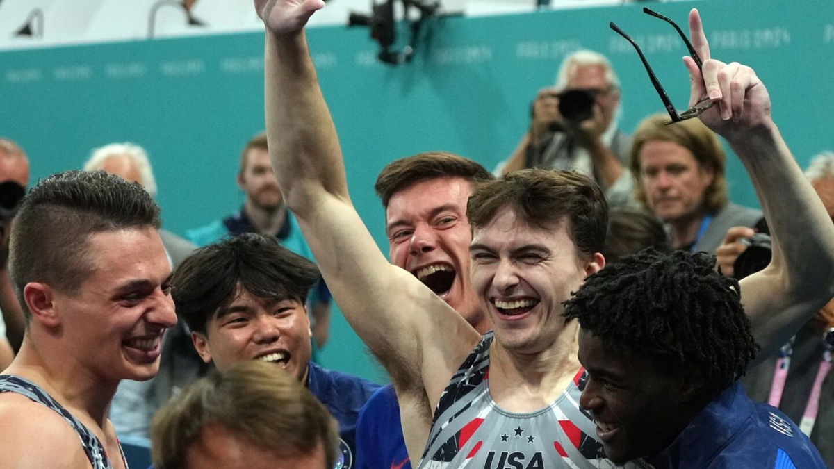 Stephen Nedoroscik celebrates with his U.S. gymnastics teammates after his pommel horse performance clinched the team's first Olympic medal since 2008.