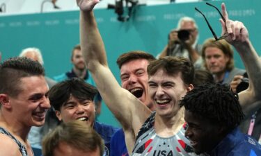 Stephen Nedoroscik celebrates with his U.S. gymnastics teammates after his pommel horse performance clinched the team's first Olympic medal since 2008.