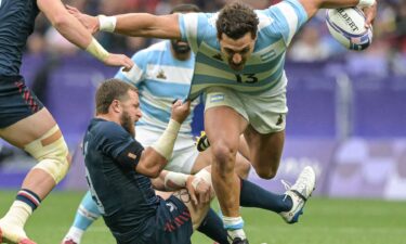 Argentina's Rodrigo Isgro is tackled by the U.S.'s Stephen Tomasin during the men's placing 7-8 rugby sevens match during the 2024 Olympic Games.