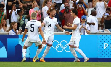 USMNT players celebrate after scoring a goal.