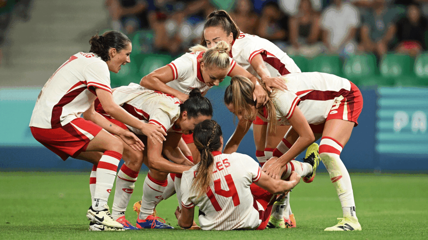 Canadian players celebrate over a stunned scorer Vanessa Gilles late in a win over France at the 2024 Paris Olympics