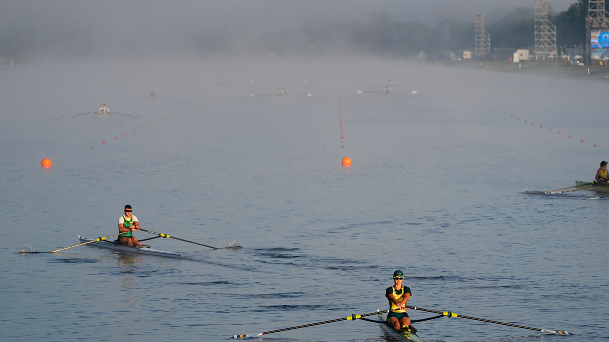 Rowers warm up before rowing competition during the Paris Olympic Games at Vaires-sur-Marne Nautical Stadium.