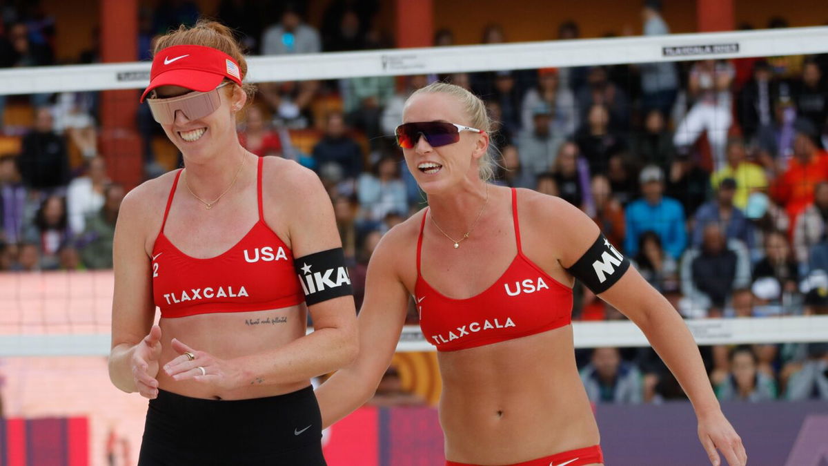 kelly cheng and sara hughes smile on beach volleyball court