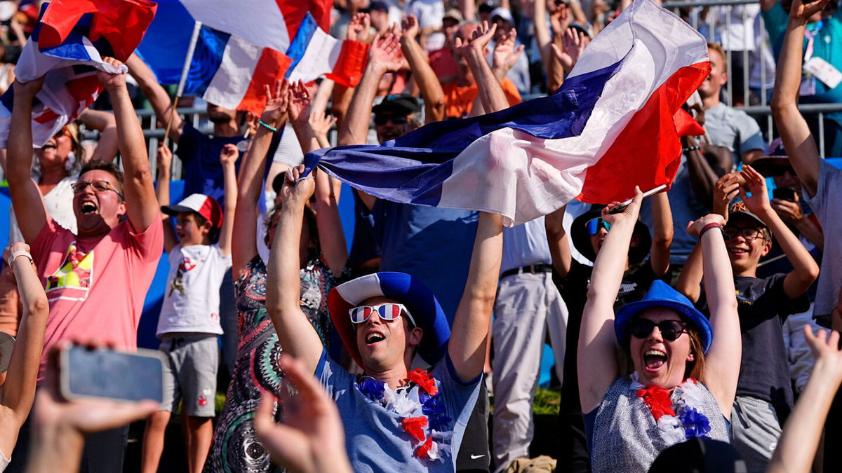 France fans celebrate during the menís canoe single final during the Paris 2024 Olympic Summer Games at Vaires-sur-Marne Nautical Stadium.