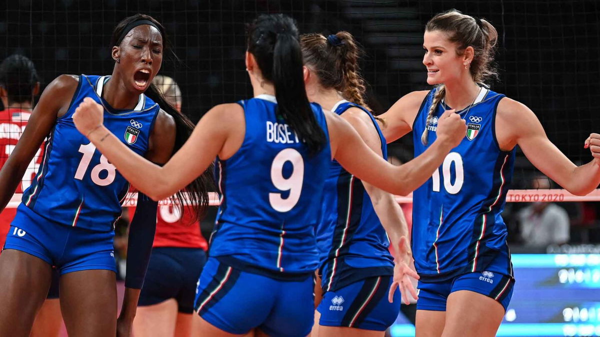 Italy's Paola Egonu (L) and Cristina Chirichella (R) react after a point in the women's preliminary round pool B volleyball match between USA and Italy during the Tokyo 2020 Olympic Games at Ariake Arena in Tokyo on August 2