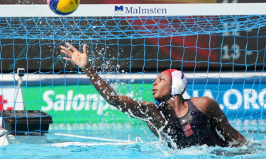 Water polo goalkeeper makes a save.