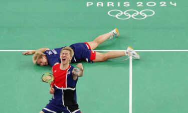 Tang Jie Chen and Ee Wei Toh of Team Malaysia celebrate during the Mixed Doubles Group Play Stage - Group D match between Team People’s Republic of China and Team Malaysia on day three of the Olympic Games Paris 2024 at Porte de La Chapelle Arena on July 29