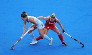 Agustina Gorzelany of Team Argentina runs with the ball whilst under pressure from Ashley Sessa of Team United States during the Women's Pool B match between Argentina and United States on day one of the Olympic Games Paris 2024 at Stade Yves Du Manoir on July 27