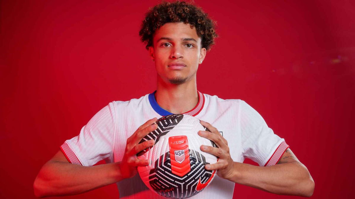 Kevin Paredes poses while holding a soccer ball