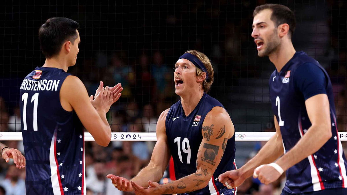 Taylor Averill #19 of Team United States celebrates with teammates Micah Christenson #11 and Matthew Anderson #1 during the Men's Preliminary Round - Pool C match between Team United States and Team Germany.