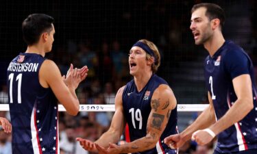 Taylor Averill #19 of Team United States celebrates with teammates Micah Christenson #11 and Matthew Anderson #1 during the Men's Preliminary Round - Pool C match between Team United States and Team Germany.