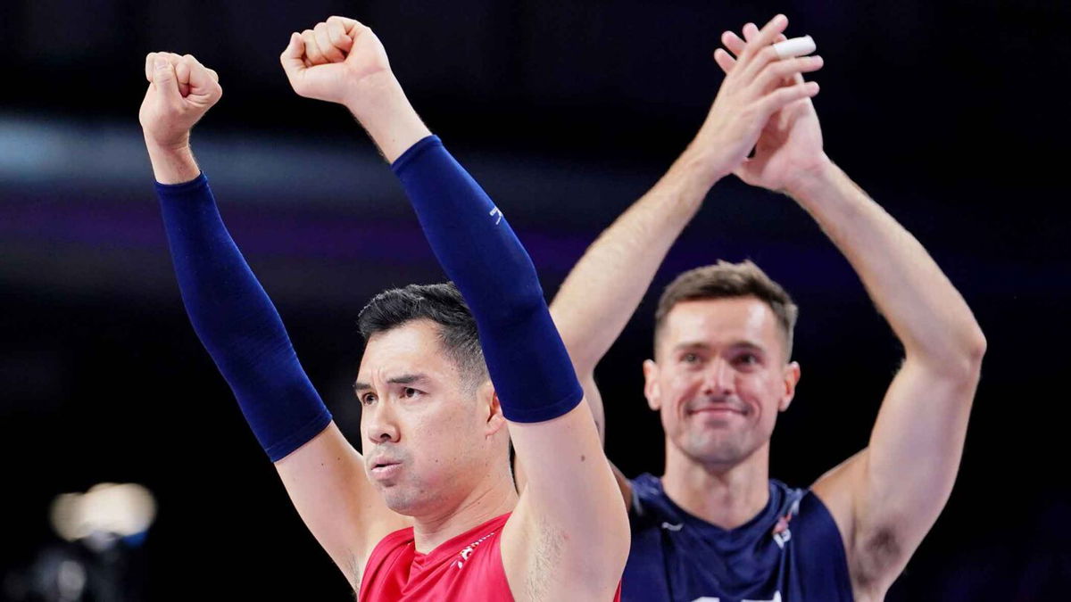 United States libero Erik Shoji (22) and outside hitter Thomas Jaeschke (17) celebrate after their win against Germany during the Paris 2024 Olympic Summer Games at South Paris Arena 1.