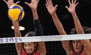 Team USA's Jordan Thompson and Haleigh Washington block the ball during the women's preliminary round volleyball match between USA and Serbia during the Paris 2024 Olympic Games at the South Paris Arena 1.