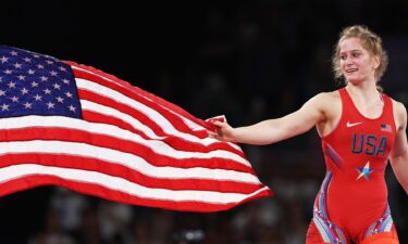 Amit Elor waves American flag