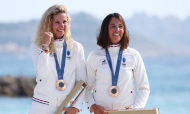 Bronze medalists Sarah Steyaert and Charline Picon of Team France celebrate at the medal ceremony of the Women's Skiff 49erFX.