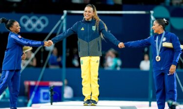 Simone Biles and Jordan Chiles congratulate gold medalist Rebeca Andrade