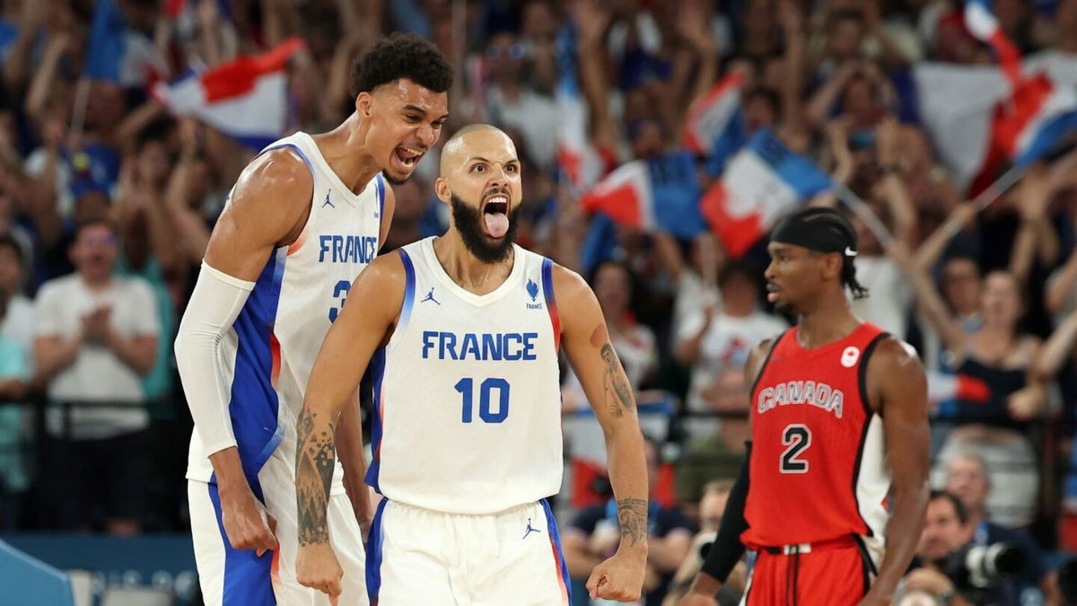 Evan Fournier and Victor Wembanyama celebrate vs. Canada