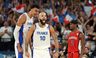 Evan Fournier and Victor Wembanyama celebrate vs. Canada