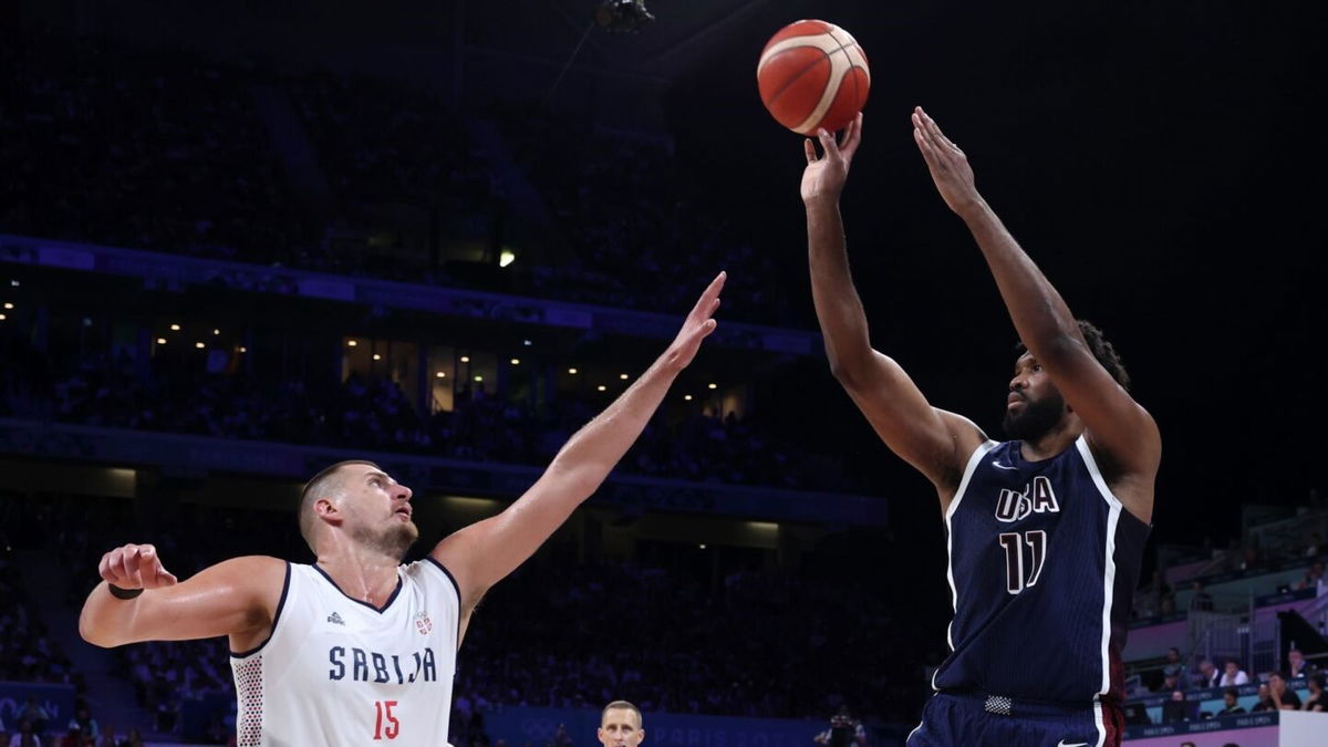 Joel Embiid shoots over Nikola Jokic