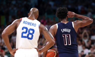 Joel Embiid gestures to the crowd