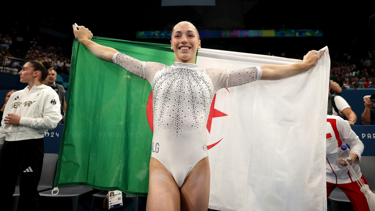 Kaylia Nemour of Algeria celebrates after winning an historic gold medal on uneven bars at the Paris 2024 Olympics.