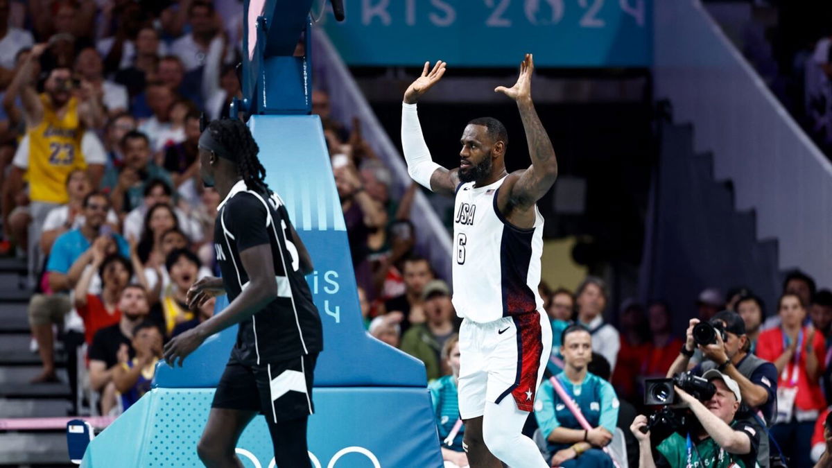 LeBron James celebrates a dunk vs. South Sudan