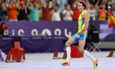 Gold medalist Mondo Duplantis of Sweden celebrates after setting a new world record during the men's pole vault at the 2024 Paris Olympics.