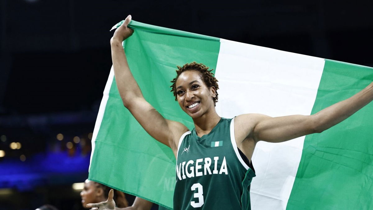 Pallas Kunaiyi-Akpanah holds flag after win vs. Canada