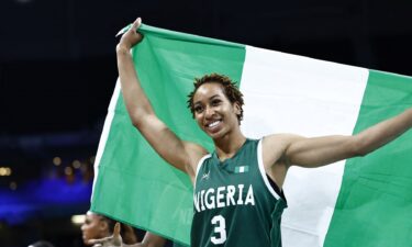 Pallas Kunaiyi-Akpanah holds flag after win vs. Canada