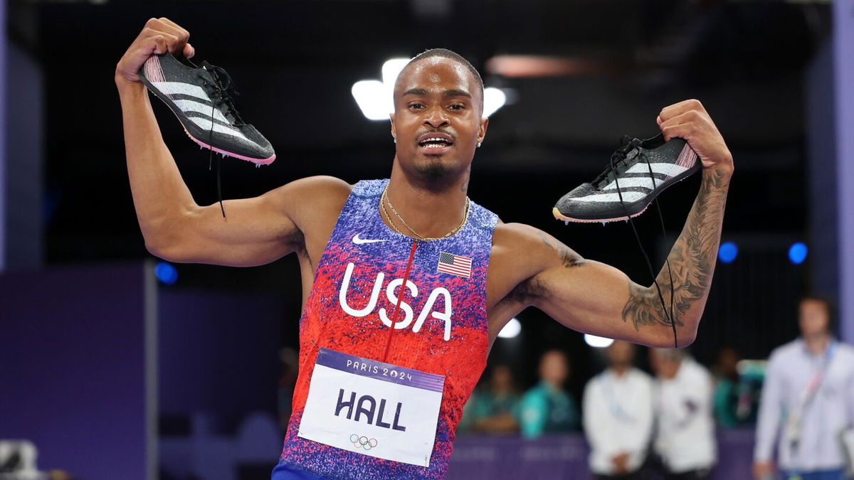 Quincy Hall celebrates by holding up his shoes