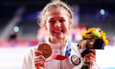 Sarah Hildebrandt holds up her Olympic bronze medal