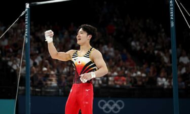 Shinnosuke Oka of Team Japan pumps his fist in the air after competing in the high bar final at the 2024 Paris Olympics.