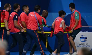 Medical staff carry Slovakia's Tamara Potocka on a stretcher after she collapsed following a heat of the women's 200m individual medley swimming event during the 2024 Paris Olympic Games