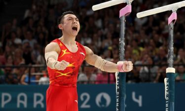 Zou Jingyuan celebrates after nailing his parallel bar routine to win the gold medal at the 2024 Paris Olympics.