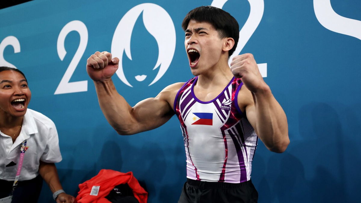 Carlos Yulo of the Philippines celebrates after finishing his routine at the men's gymnastics floor exercise final at the 2024 Paris Olympics.