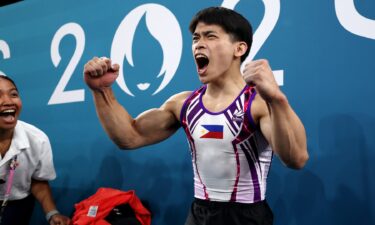 Carlos Yulo of the Philippines celebrates after finishing his routine at the men's gymnastics floor exercise final at the 2024 Paris Olympics.