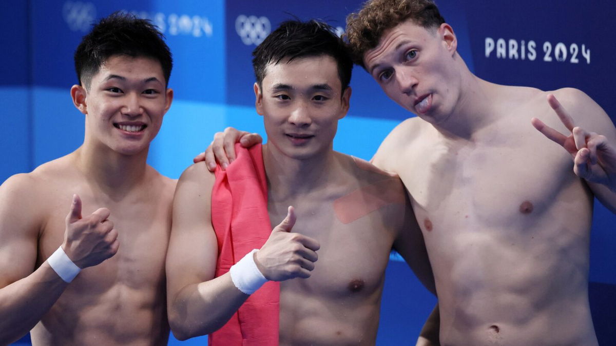 Cao Yuan poses alongside Rikuto Tamai and Noah Williams after the men's 10m platform final.