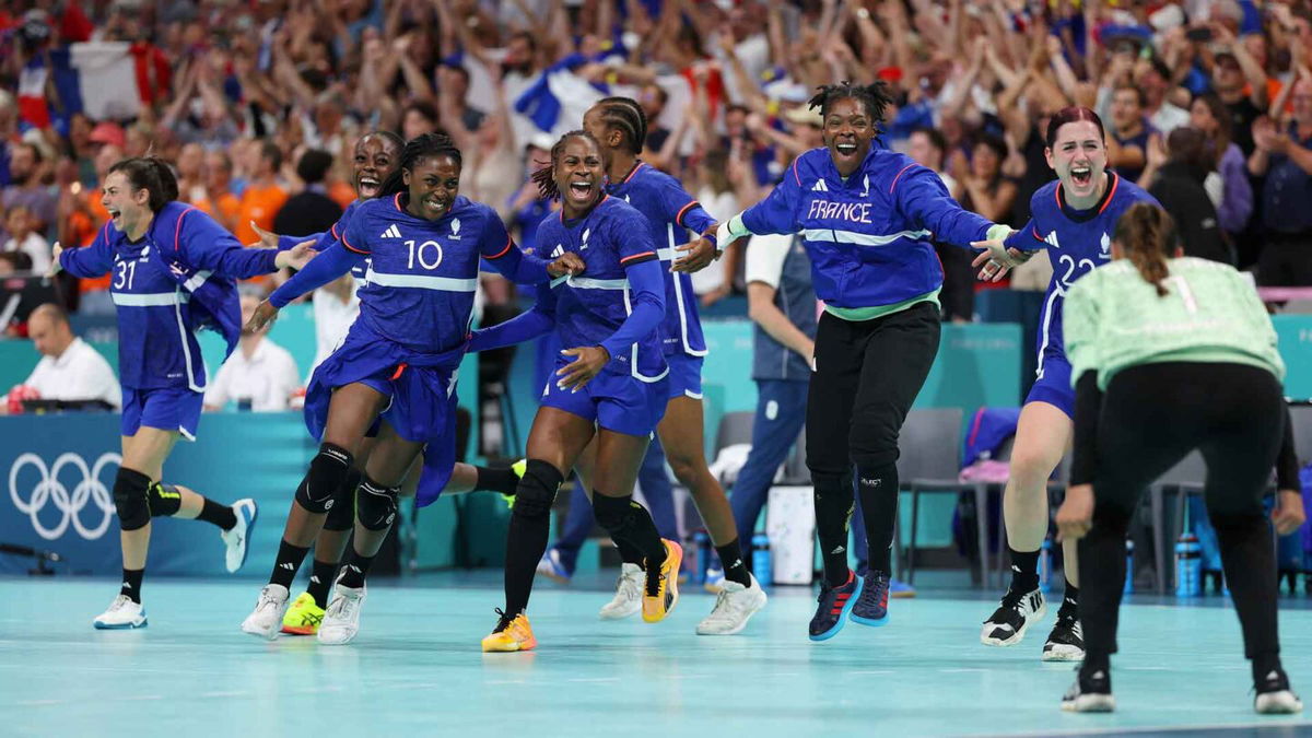 France women's handball team celebrates after winning a quarterfinal match