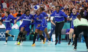 France women's handball team celebrates after winning a quarterfinal match