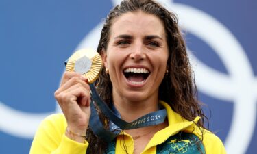 Australia's Jessica Fox posts with her gold medal for the women's canoe slalom single event at the 2024 Paris Olympics.