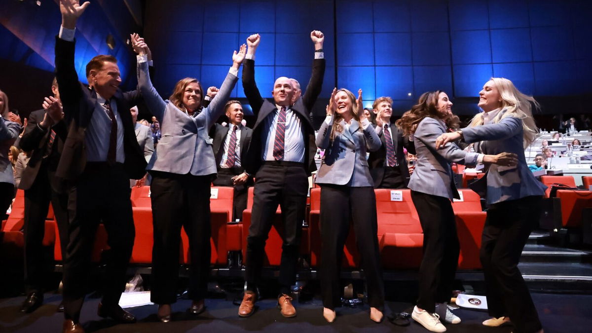 Members of the Utah 2034 delegation celebrate as Salt Lake City