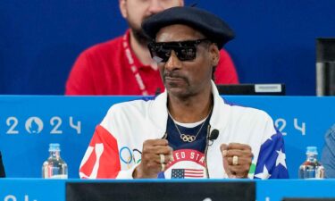 Snoop Dogg watches an event at the Olympics