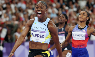 Julien Alfred of Saint Lucia crosses the finish line during the women's 100m final at Stade de France.