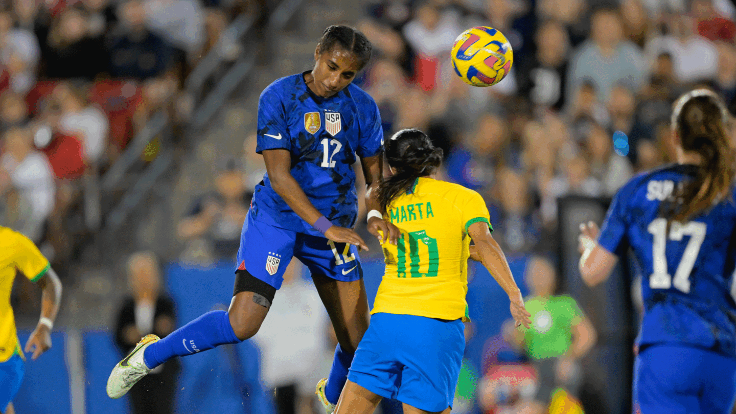 Naomi Girma of the USWNT heads a ball over Marta of Brazil