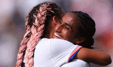 Trinity Rodman and Naomi Girma embrace after the USWNT defeated Japan at the Olympics