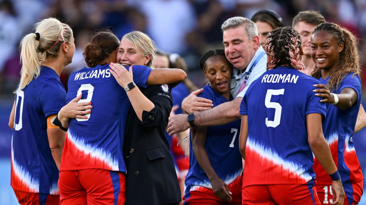 Emma Hayes and Lynn Williams embrace following the USWNT's 1-0 win over Brazil in the gold medal match