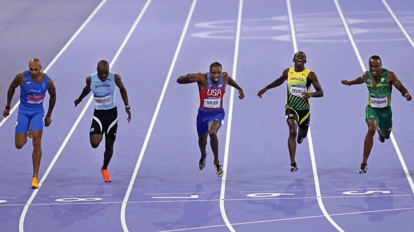 Noah Lyles surges toward the finish line in his photo finish win in the 100m dash at the Olympics