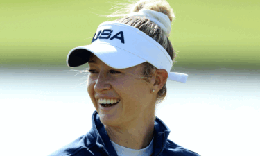 Nelly Korda smiles underneath a white visor at Day 1 of women's golf at the 2024 Paris Olympics