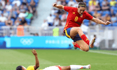 Mariona Caldentey of Spain (red shirt) jumps over Carolina Arias (yellow) of Colombia