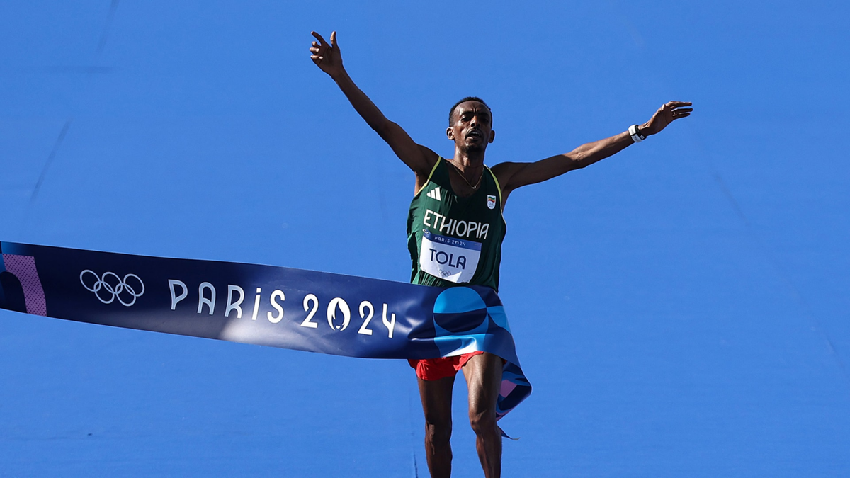 Tamirat Tola of Ethiopia celebrates after the men's marathon at the Paris Olympics